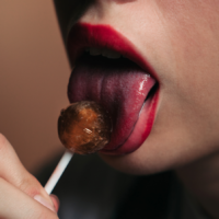 woman licking lollipop