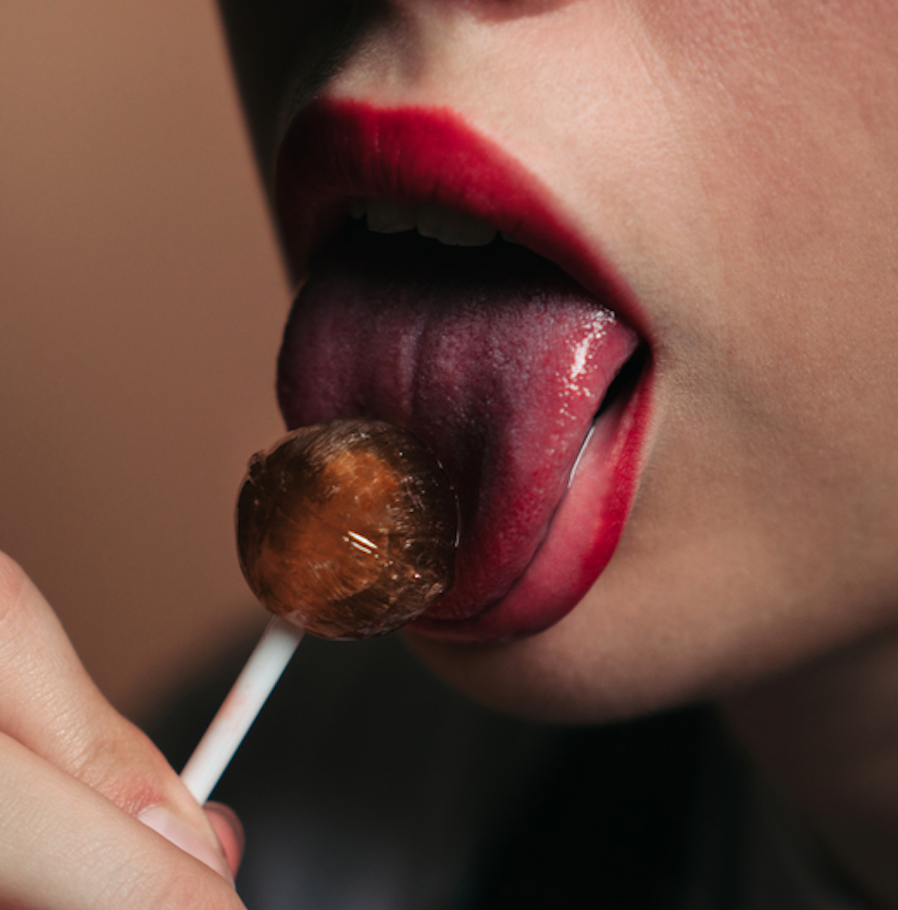 woman licking lollipop