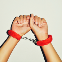 red handcuffs on hands