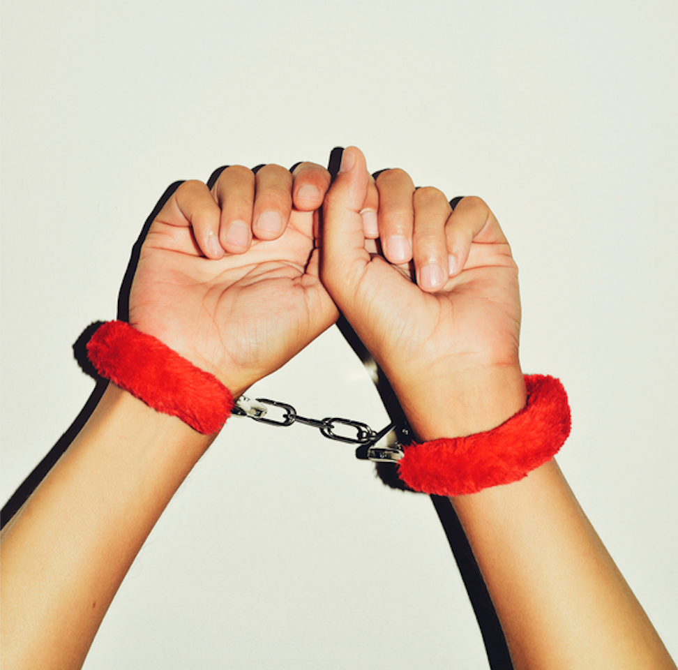 red handcuffs on hands