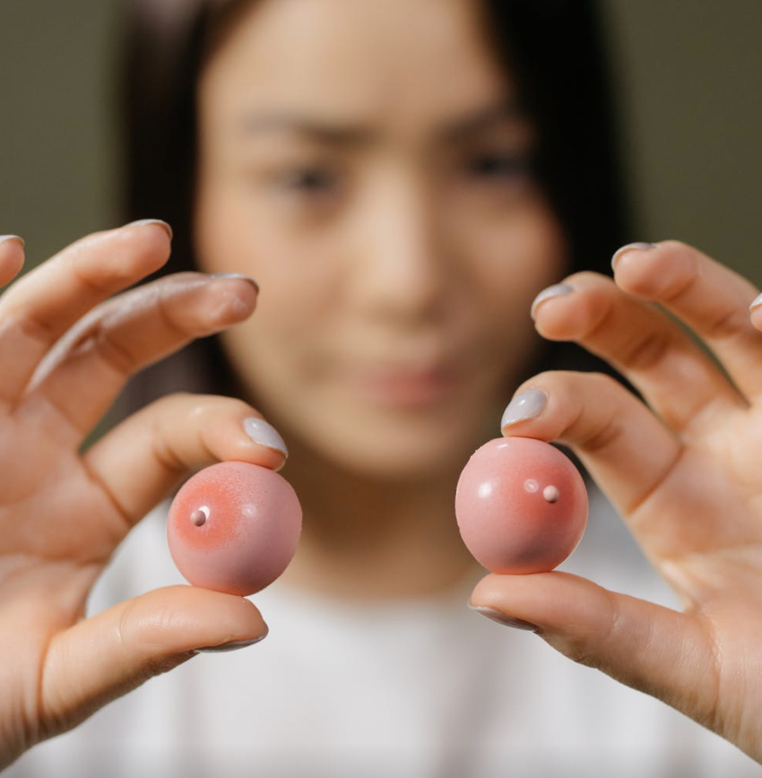 girl holding two tiny balls