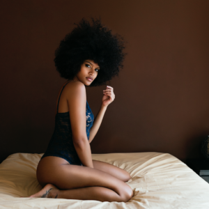 Black woman sitting on the bed