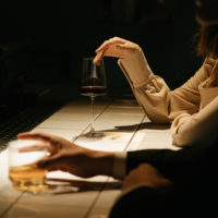 man and woman at a bar drinking cocktails before going to the bedroom