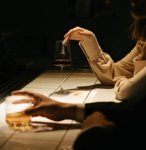 man and woman at a bar drinking cocktails before going to the bedroom