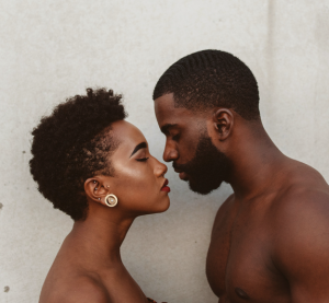 black couple leaning close to kiss