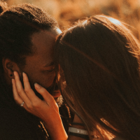 couple kissing in a field