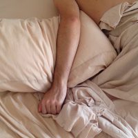 hand of a person laying in bed