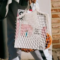 Person holding bag full of items