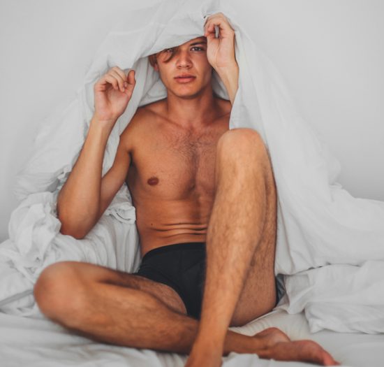 Young Man Covering Himself With Sheet.
