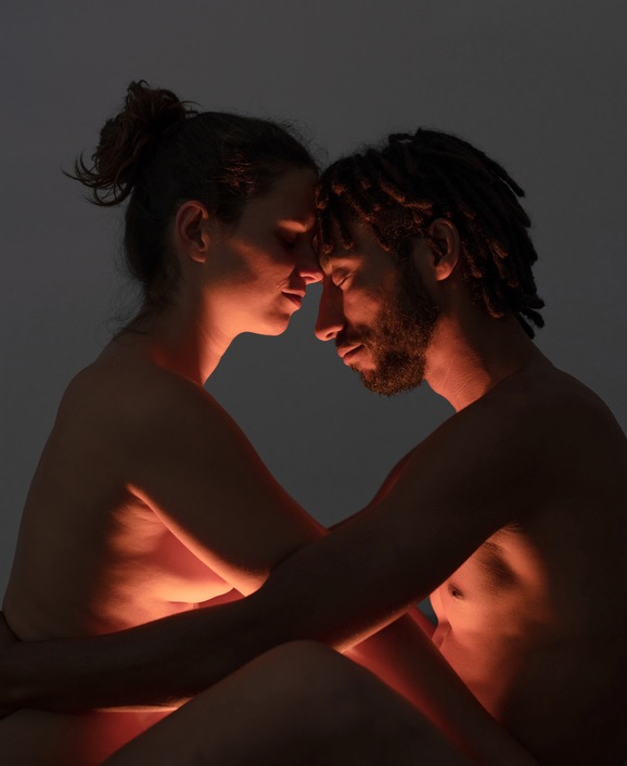 Couple embracing each other with a light shining below