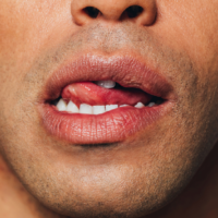 Close up of a man licking his upper lip