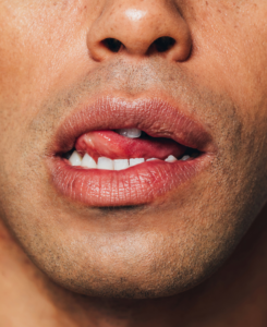 Close up of a man licking his upper lip