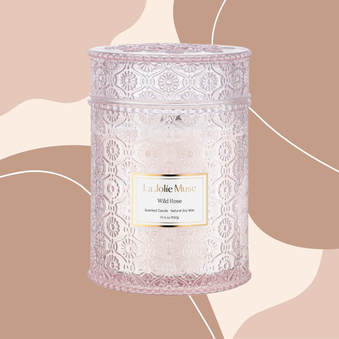 Le Jolie Wild Rose Candle on pink/brown abstract shape background