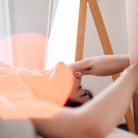 Soft focus image of woman in bed experiencing orgasm