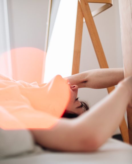 Soft focus image of woman in bed experiencing orgasm