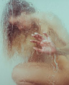 Aesthetic female portraits in the shower with textures blurring the face and the body