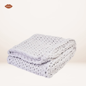 Bearable Knitted Blanket on pale background with SWE lips logo in upper right corner