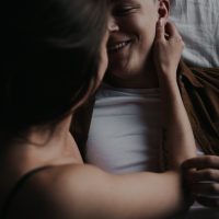 Young attractive couple intimate cuddling in bed