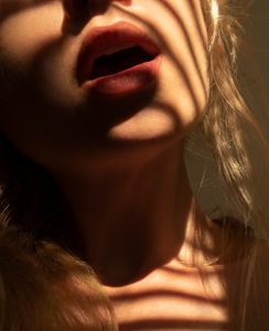 sensual lips and sunlight and shadow lines closeup blonde beauty potrait