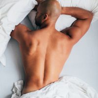 young man lying in the bed, sleeping