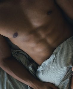 Man lying in bed shirtless